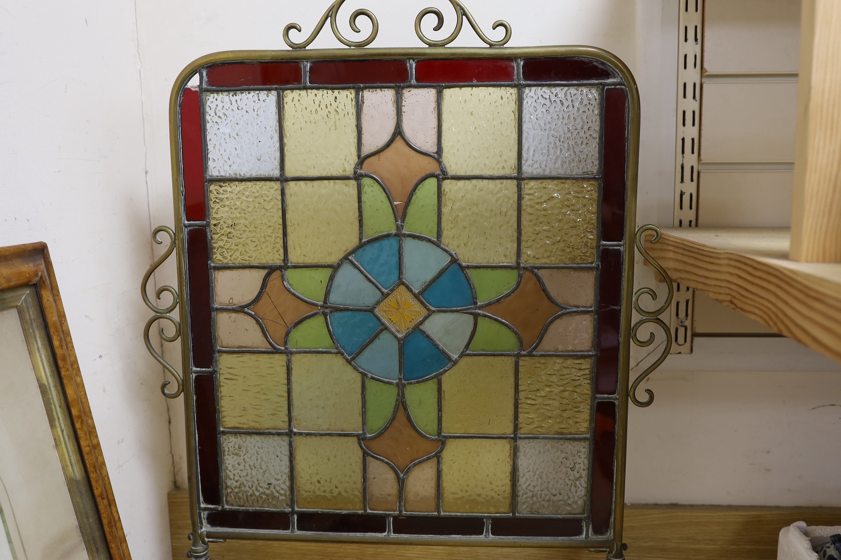 A Victorian embossed copper shot flask, postal scales and weights, plated items, a display knife and fork and a stained glass fireguard-55cms x 72cms high
